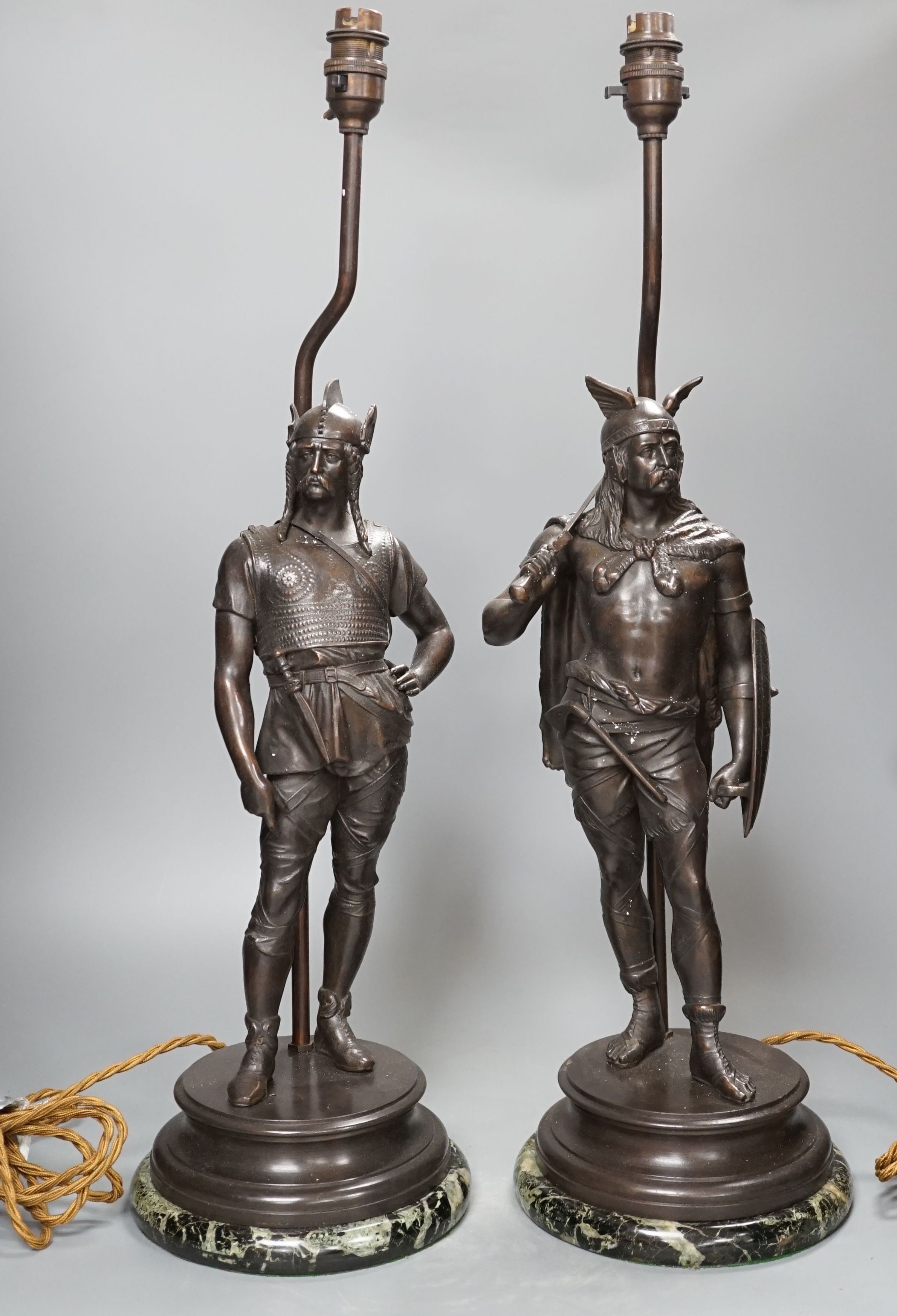 A pair of spelter warrior lamps on marbled plinth base - 62cm high